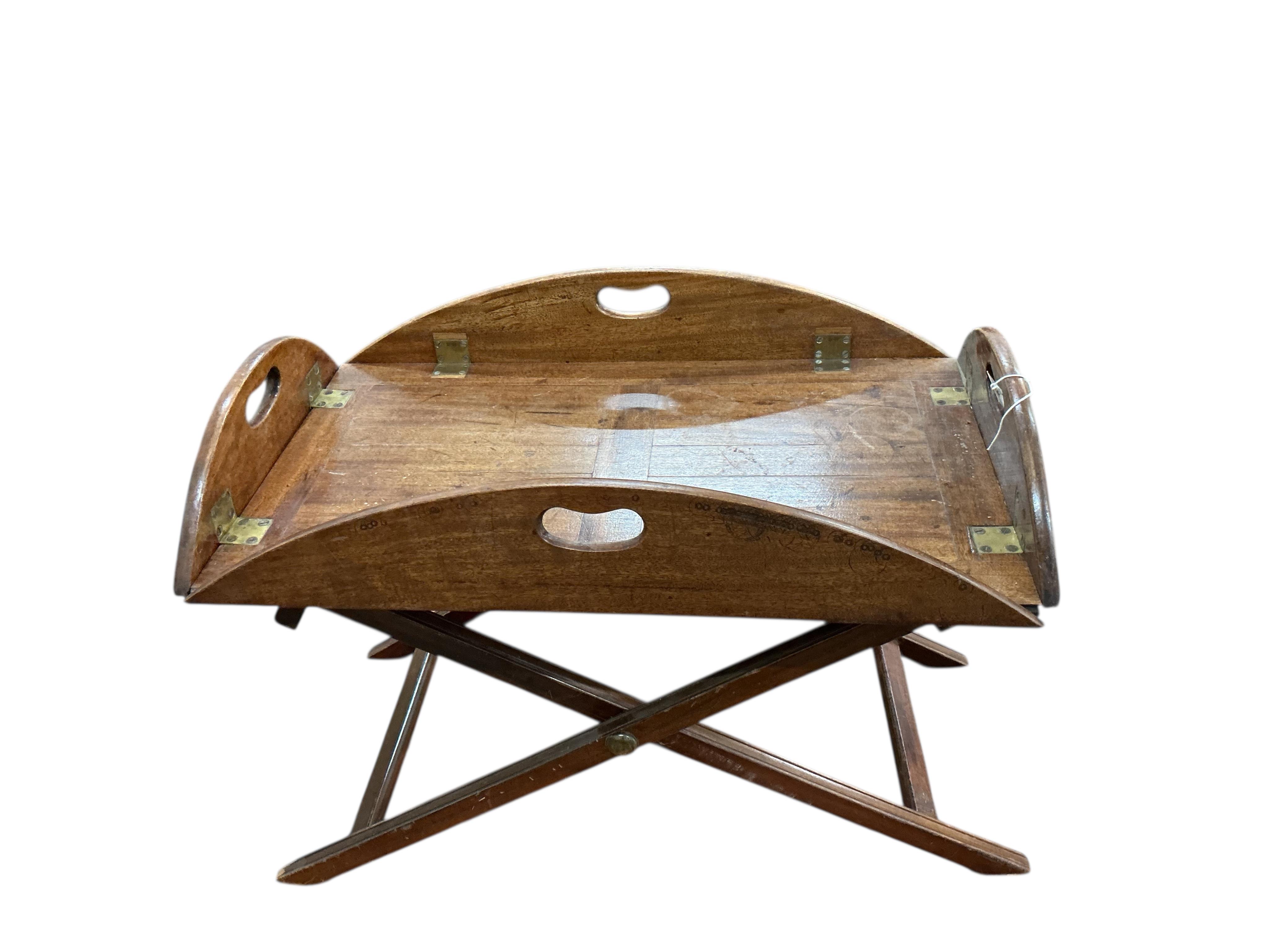 A George III style oval mahogany butler's tray on folding stand, width 70cm, depth 42cm, height 52cm
